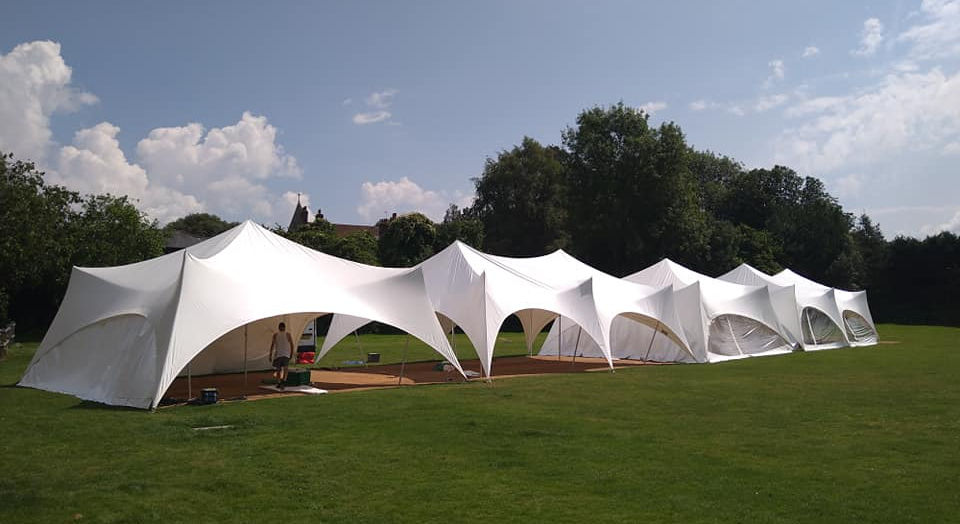Wide joined Capri marquee installation on a lawn